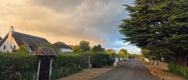 Sea Way on an August evening, grass verges and hedges under a dramatic sky